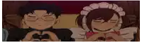 a boy and a girl making a heart with their hands