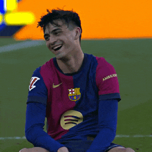 a soccer player wearing a shirt that says ambitious on the sleeve