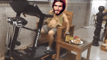 a man sitting on a treadmill with the word sport on it