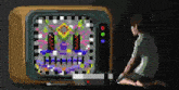 a pixel art drawing of a boy sitting in front of a television