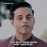 a man in a suit and plaid shirt is talking about being exactly who he wants to be