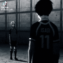 a man with the number 11 on his shirt stands next to another man