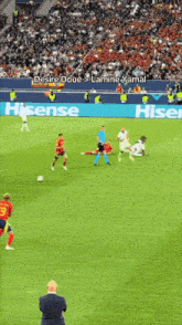 a soccer game is being played on a field with a hisense advertisement