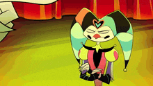 a cartoon character with a heart on his head is standing in front of a red curtain