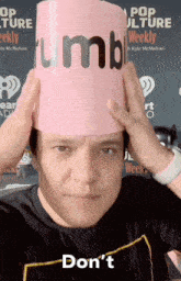a man wearing a pink hat that says " tumble " on it