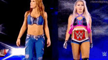a couple of women standing next to each other on a stage . one of the women is wearing a wrestling belt .