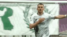 a soccer player wearing a white shirt that says lotto
