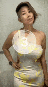 a woman in a white and yellow dress is standing in front of a clock that says 3