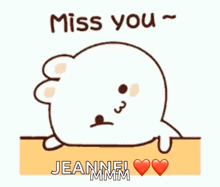 a cartoon seal is sitting on a table with the words `` miss you '' written on it .