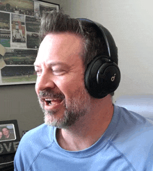 a man wearing headphones is singing in front of a love sign
