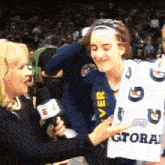 a woman holding a sign that says gatorade