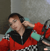 a woman wearing headphones sits in front of a microphone with viaje written on the bottom