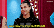 a man with long hair is smiling and saying " jorgeous , you are such a little slut "