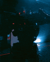 a robot in a dark room with a red light shining on it