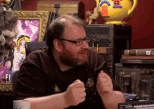 a man sitting at a desk with a mug that says " i love you "
