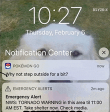 a phone screen shows a notification from the notification center about an emergency alert