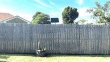 a wooden fence with a potted plant in the middle of it