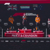 a man stands on a podium with the words max verstappen