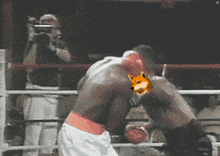 two boxers are fighting in a ring and one has a doge on his face