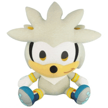 a stuffed sonic the hedgehog is sitting on a white background