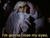a woman laying in bed with the words " i 'm gonna close my eyes " on the bottom