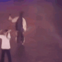 a blurry picture of a person standing on a stage .