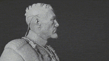 a black and white photo of a man with a mohawk