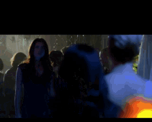 a group of people are gathered in a dark room