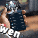a person is holding a phone with a cat on the screen