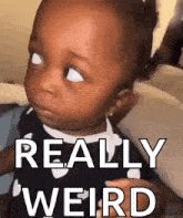 a baby is making a funny face and the words really weird are behind it .