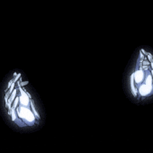 a pair of blue and white gloves are glowing on a black background