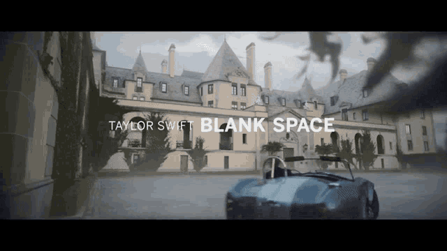 a car is parked in front of a large building with the words 