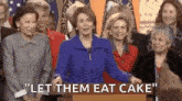 a group of women are standing around a podium and a woman is standing in front of them .