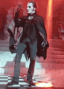 a man in a cape is standing on a checkered floor
