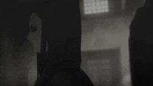 a black and white image of a woman with a hood on