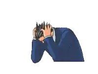 a man in a suit is holding his head with his hands