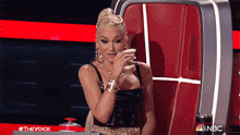 a woman sitting in a chair with a nbc logo on the bottom