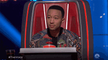 a man sits in a chair with a nbc logo on the bottom