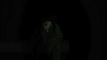 a man in a green suit is standing in the dark