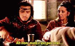 a man and a woman are sitting at a table and the man says " ah non mais c est pas vrai "