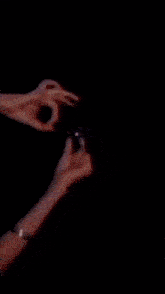 a person 's hands are reaching out towards a galaxy of lights