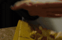 a blurred image of a person cutting a piece of wood