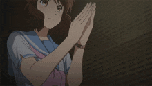 a girl with a watch on her wrist is making a gesture with her hands