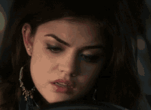 a close up of a woman 's face with a serious look on her face