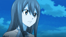 a close up of a girl 's face with a blue sky behind her