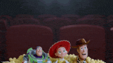 buzz lightyear jessie and woody from toy story are sitting in a pile of popcorn