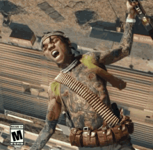 a man with a tattooed body is holding a gun and has the letter m on the bottom left