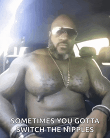 a shirtless man in a car with the words sometimes you gotta switch the nipples