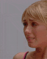 a close up of a woman 's face with tears running down her face