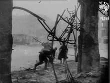 a black and white photo of a destroyed building with the words " the pathe " at the bottom
